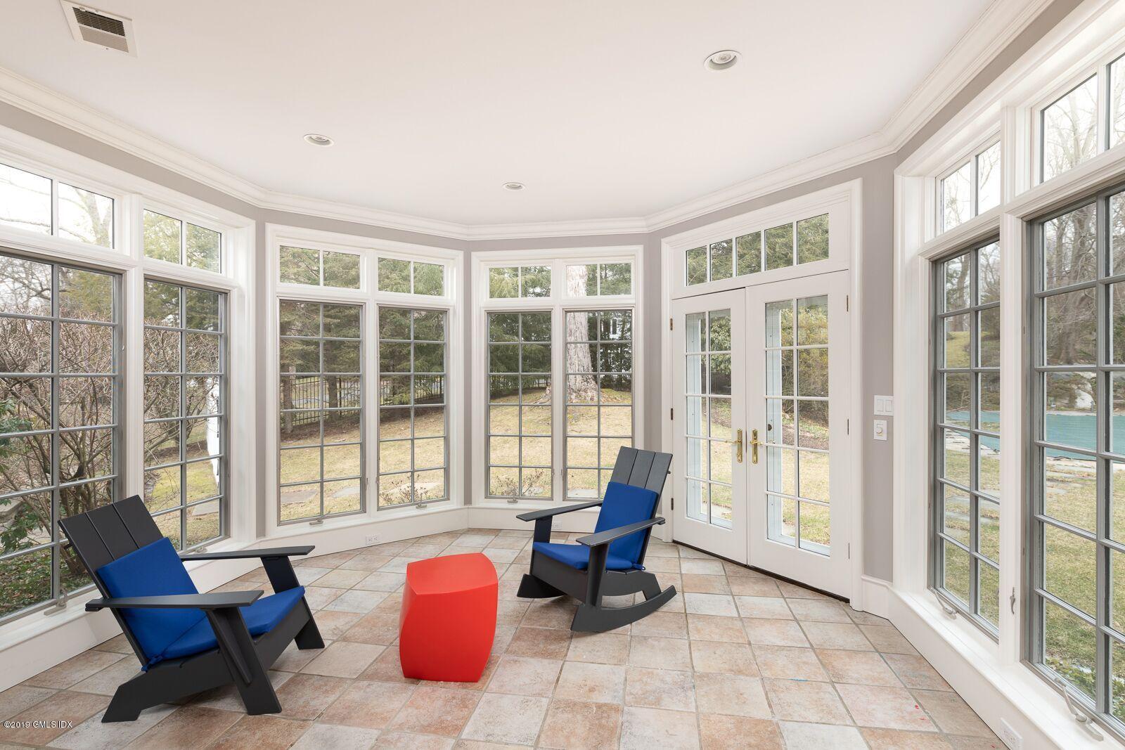35 Copper Beech Road Greenwich, CT 06830 - Photo 3 of 26 a living room filled with furniture and large windows