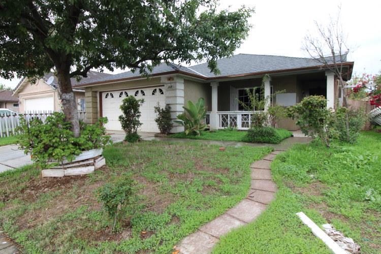 661 Barbara Court Merced, CA 95341 - Photo 3 of 18 a front view of a house with a yard and porch