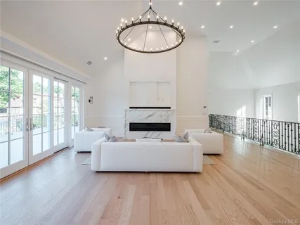 a living room with furniture a window and a chandelier