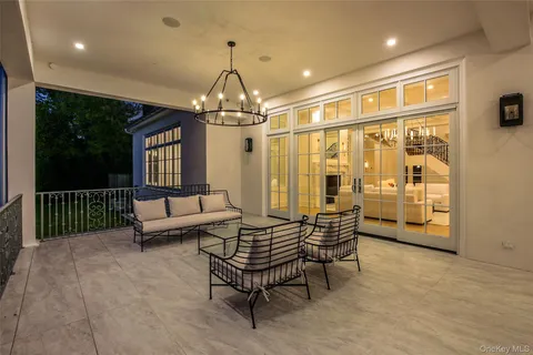 a living room with furniture and a chandelier