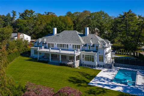 a view of a house with garden and trees