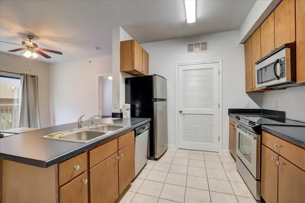 a kitchen with a sink cabinets and stainless steel appliances