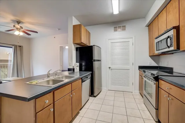 a kitchen with a sink cabinets and stainless steel appliances