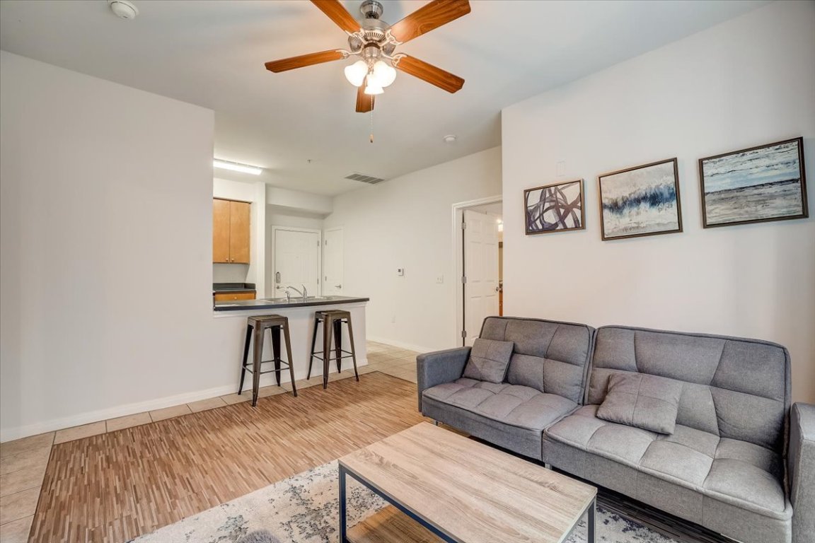 2515 Pearl Street, Unit 212 Austin, TX 78705 - Photo 4 of 10 a living room with furniture and a wooden floor