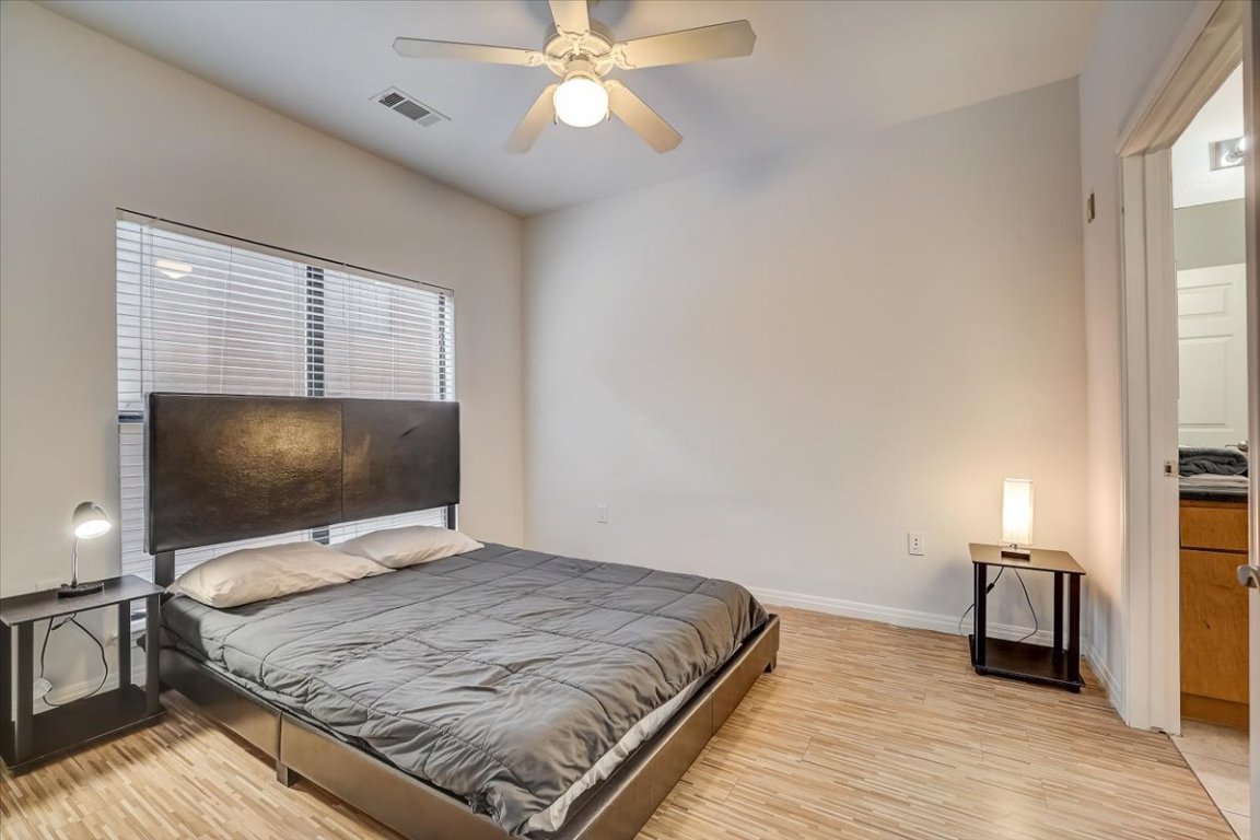 2515 Pearl Street, Unit 212 Austin, TX 78705 - Photo 5 of 10 a bedroom with a bed and a flat screen tv