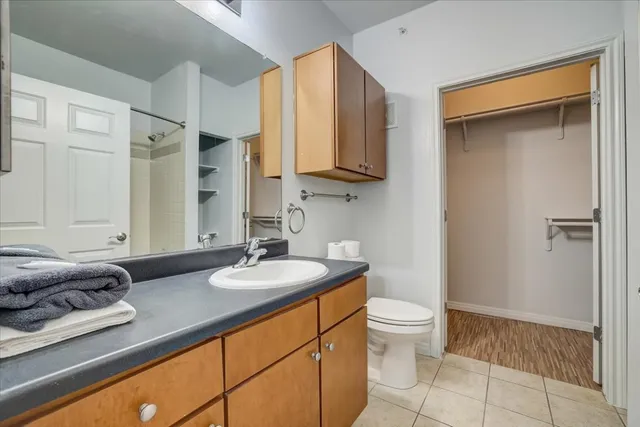 a bathroom with a granite countertop sink toilet and shower