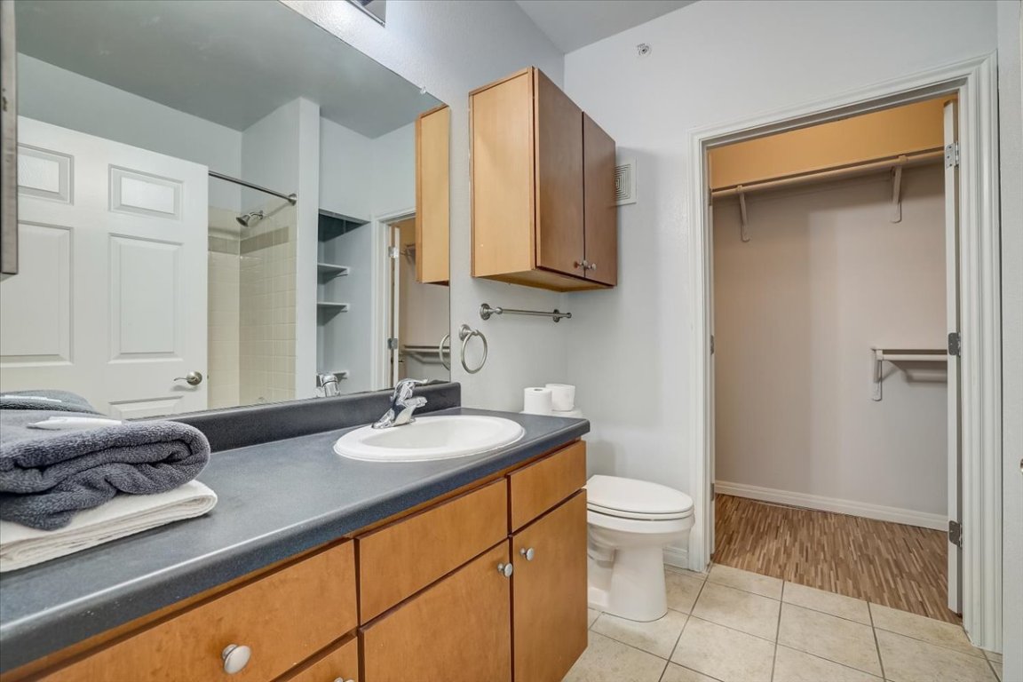 2515 Pearl Street, Unit 212 Austin, TX 78705 - Photo 8 of 10 a bathroom with a granite countertop sink toilet and shower