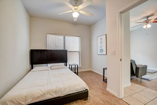 a bedroom with a bed and a chandelier