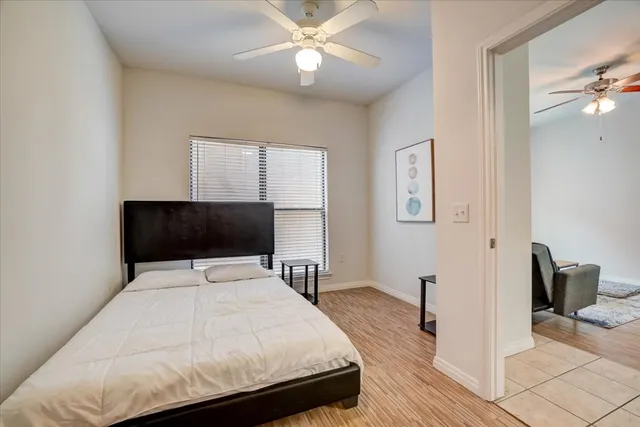 a bedroom with a bed and a chandelier