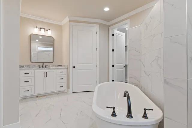 a view of an empty walk in closet with wooden floor