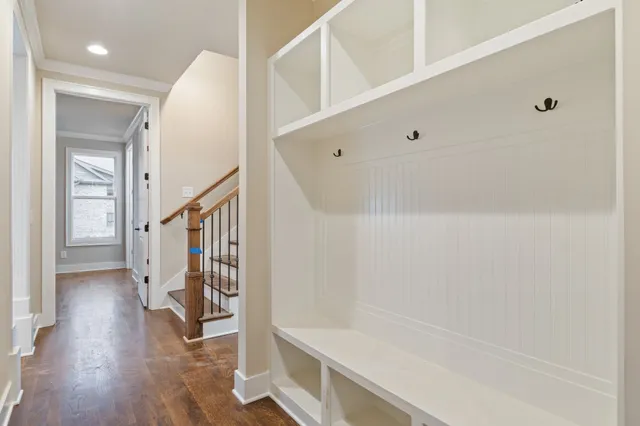 an empty room with wooden floor and ceiling fan