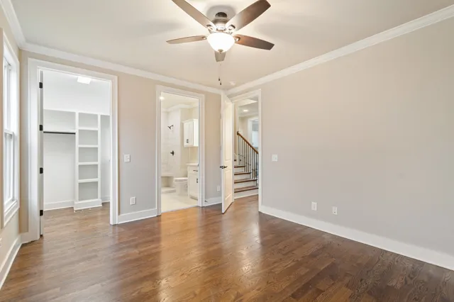 a bathroom with a granite countertop sink a toilet and shower
