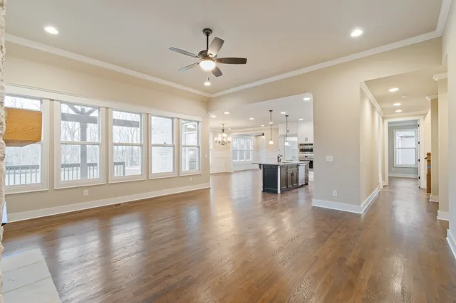 a kitchen with stainless steel appliances kitchen island granite countertop a refrigerator and cabinets