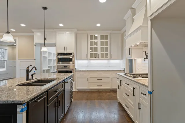 a kitchen with a sink stove and refrigerator