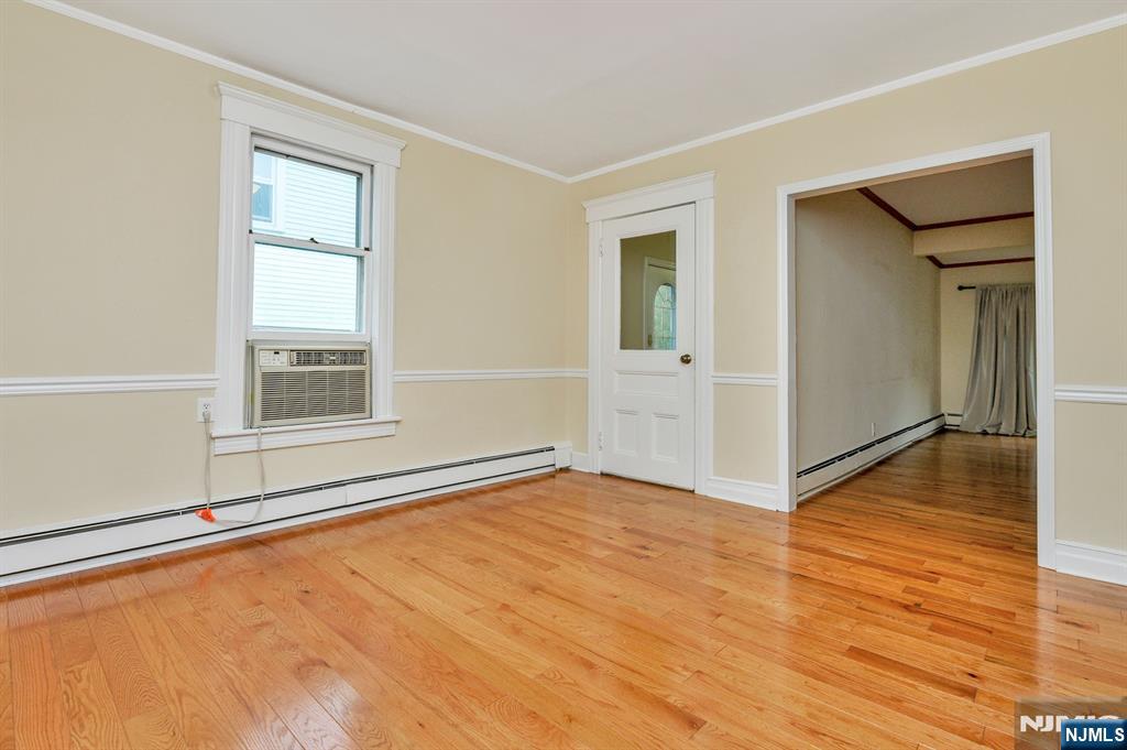 32 Washburn Place, Unit 1 Caldwell, NJ 07006 - Photo 5 of 16 a view of an empty room with wooden floor and a window