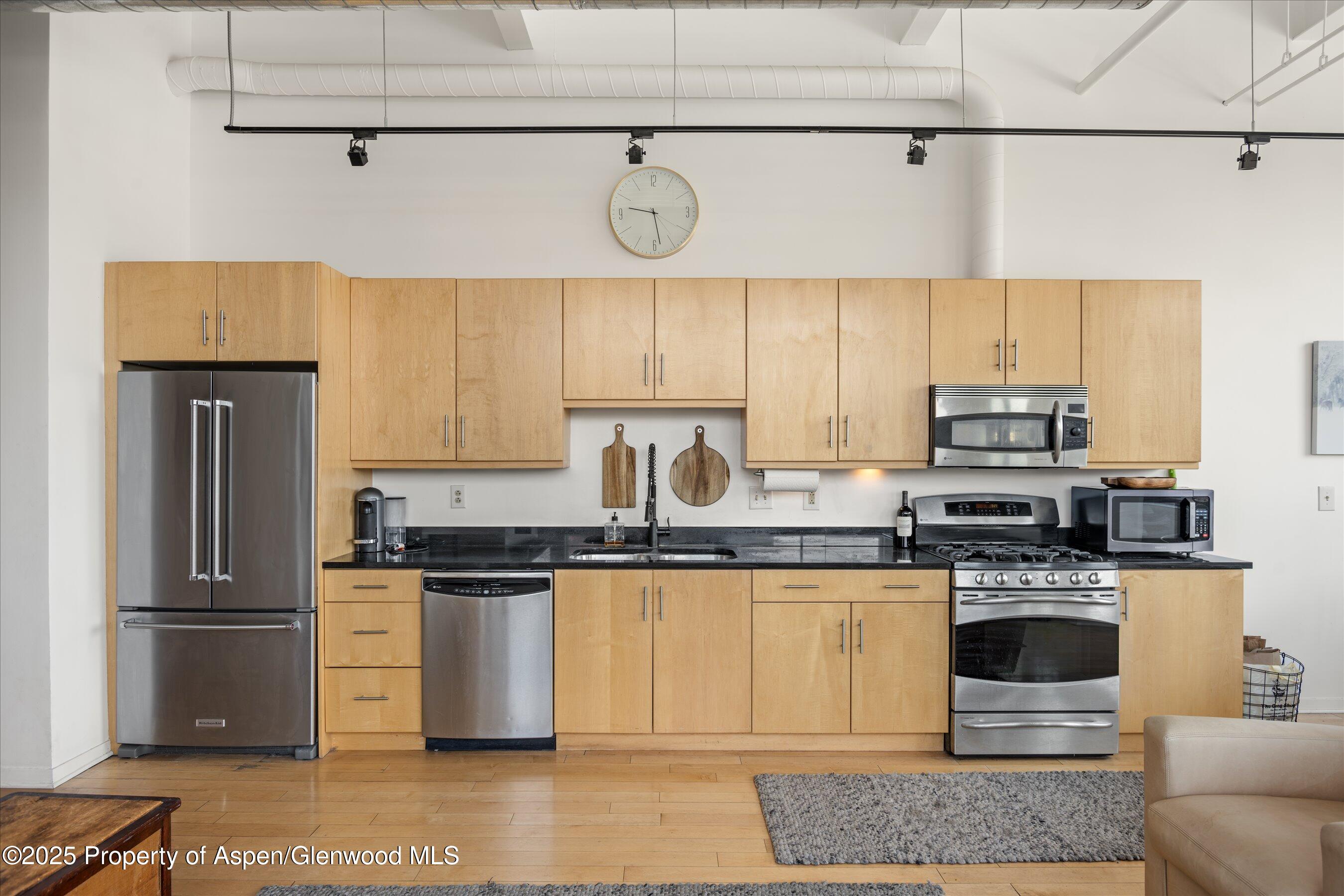 361 Robinson Street, Unit 308 Basalt, CO 81621 - Photo 11 of 23 a kitchen with stainless steel appliances granite countertop a stove a refrigerator and a sink