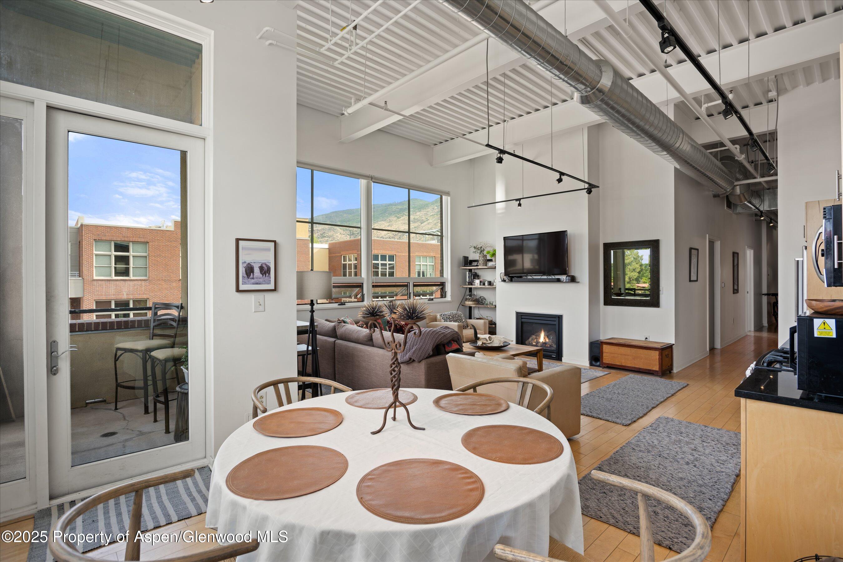 361 Robinson Street, Unit 308 Basalt, CO 81621 - Photo 12 of 23 a dining room with furniture a wooden floor and a large window