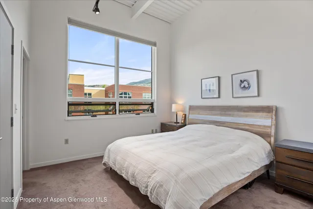 a bathroom with a granite countertop sink mirror and a toilet