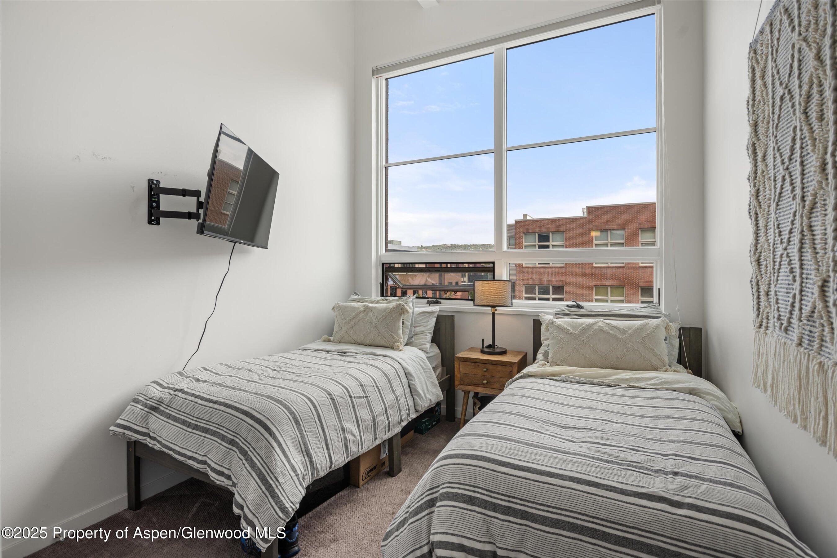 361 Robinson Street, Unit 308 Basalt, CO 81621 - Photo 16 of 23 a bedroom with two beds and a large window