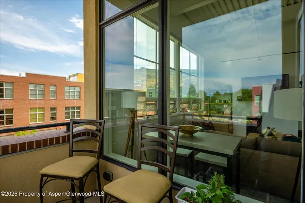 a picture of a glass door with a balcony view