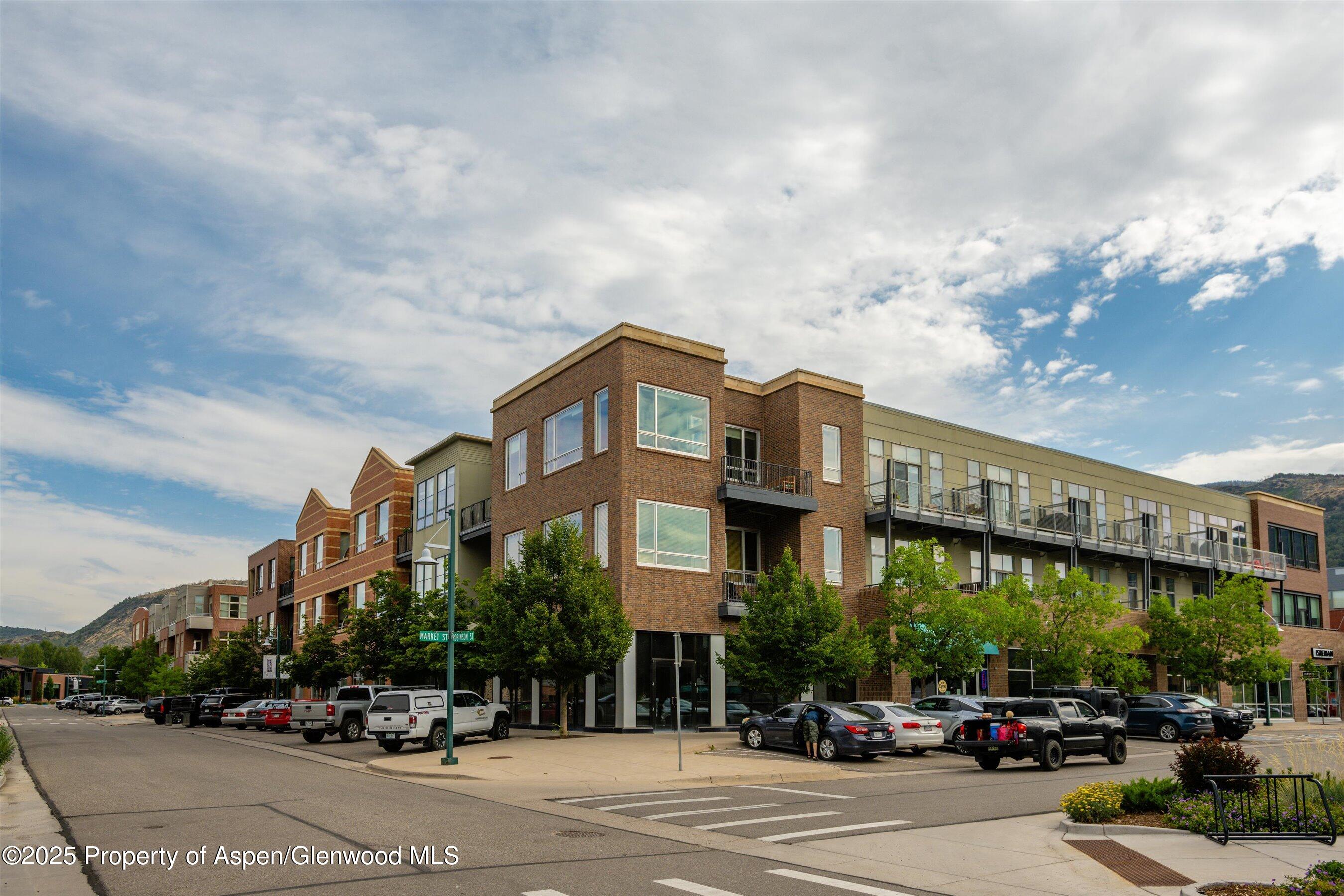 361 Robinson Street, Unit 308 Basalt, CO 81621 - Photo 2 of 23 a city street lined with buildings and cars