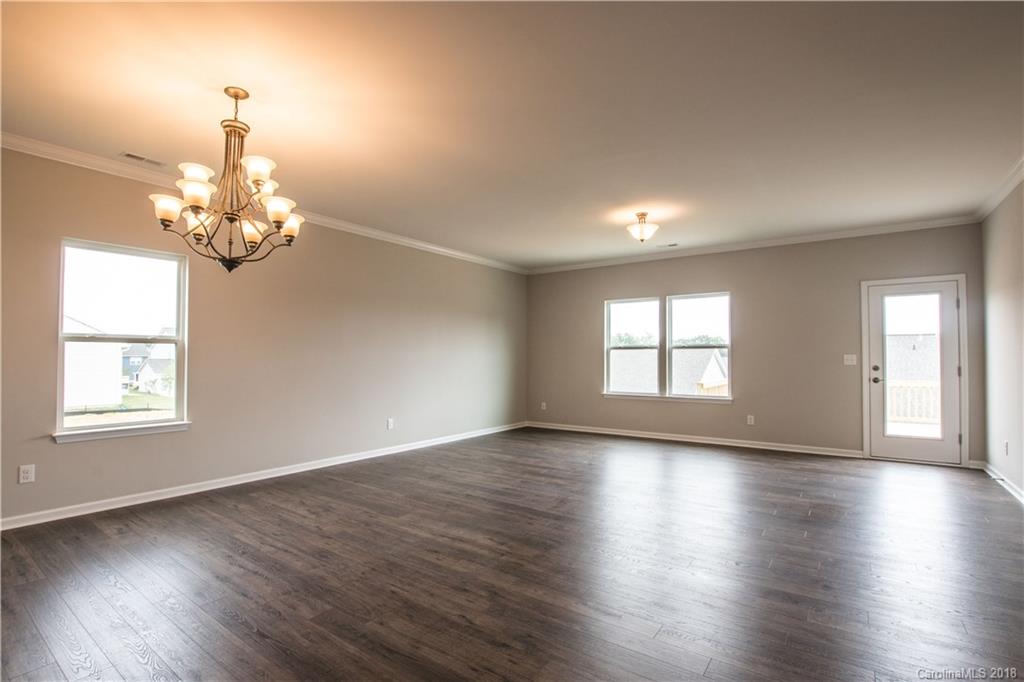 1889 Larkspur Way Tega Cay, SC 29708 - Photo 15 of 29 an empty room with wooden floor and windows