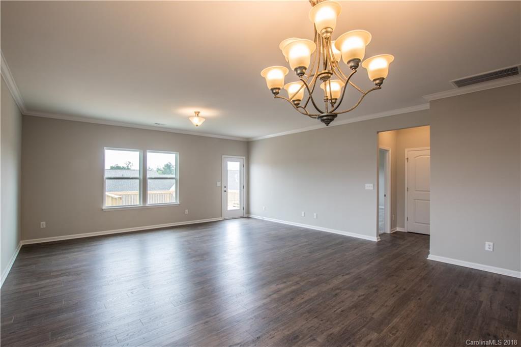 1889 Larkspur Way Tega Cay, SC 29708 - Photo 16 of 29 a view of an empty room with wooden floor and a window