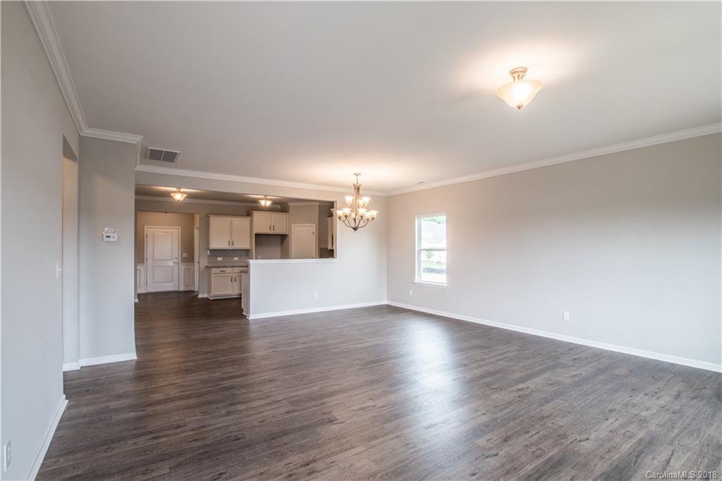 1889 Larkspur Way Tega Cay, SC 29708 - Photo 18 of 29 a view of an empty room with a window and wooden floor