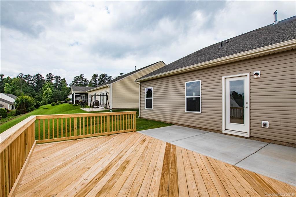 1889 Larkspur Way Tega Cay, SC 29708 - Photo 22 of 29 a view of a house with a wooden deck