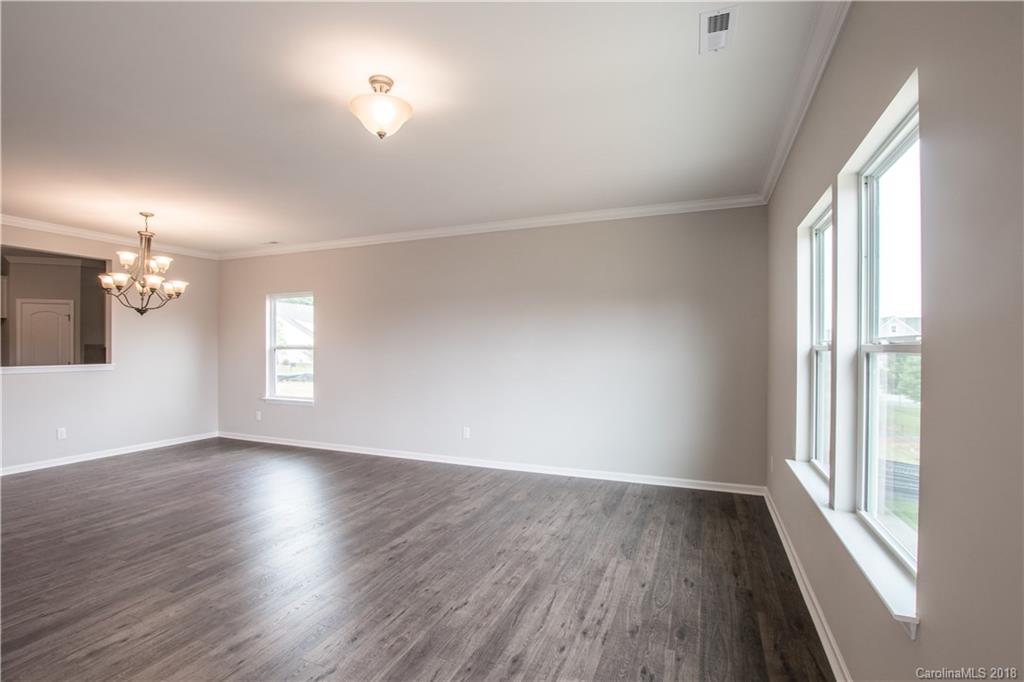 1889 Larkspur Way Tega Cay, SC 29708 - Photo 23 of 29 an empty room with wooden floor and windows