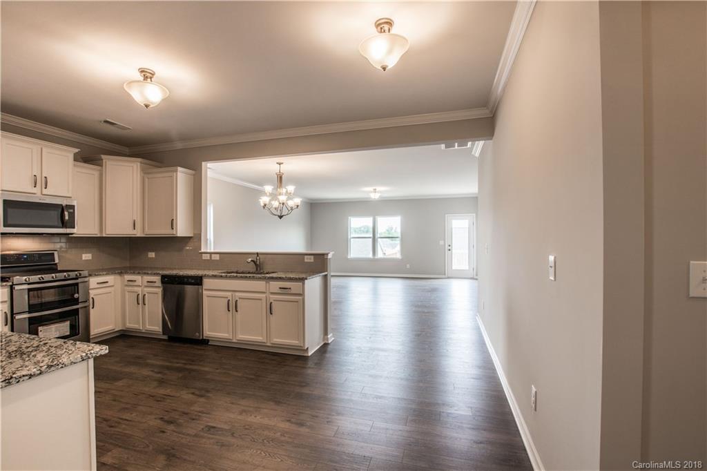 1889 Larkspur Way Tega Cay, SC 29708 - Photo 8 of 29 a large kitchen with hardwood floor and a view of kitchen