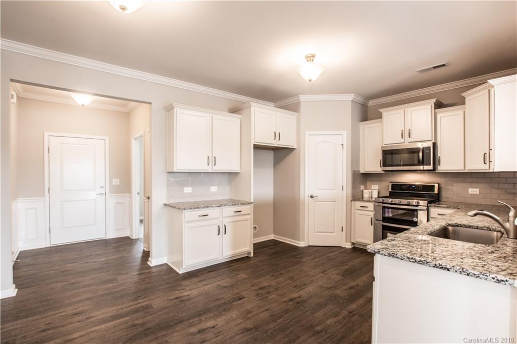 1889 Larkspur Way Tega Cay, SC 29708 - Photo 10 of 29 a kitchen with granite countertop a refrigerator stove top oven and sink