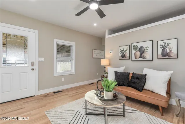 a living room with furniture and wooden floor