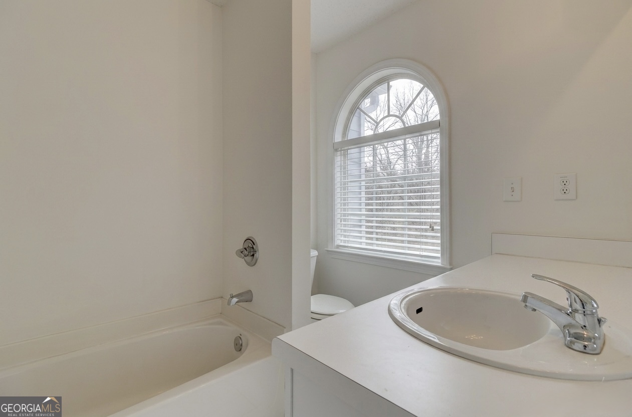 2851 Walden Lake Bend Decatur, GA 30035 - Photo 13 of 17 a bathroom with a bathtub and a window