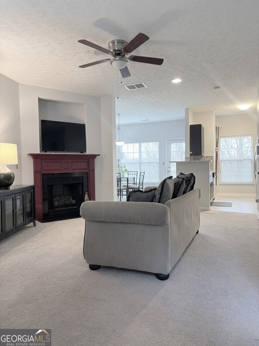 2851 Walden Lake Bend Decatur, GA 30035 - Photo 4 of 17 a living room with furniture a fireplace and a flat screen tv