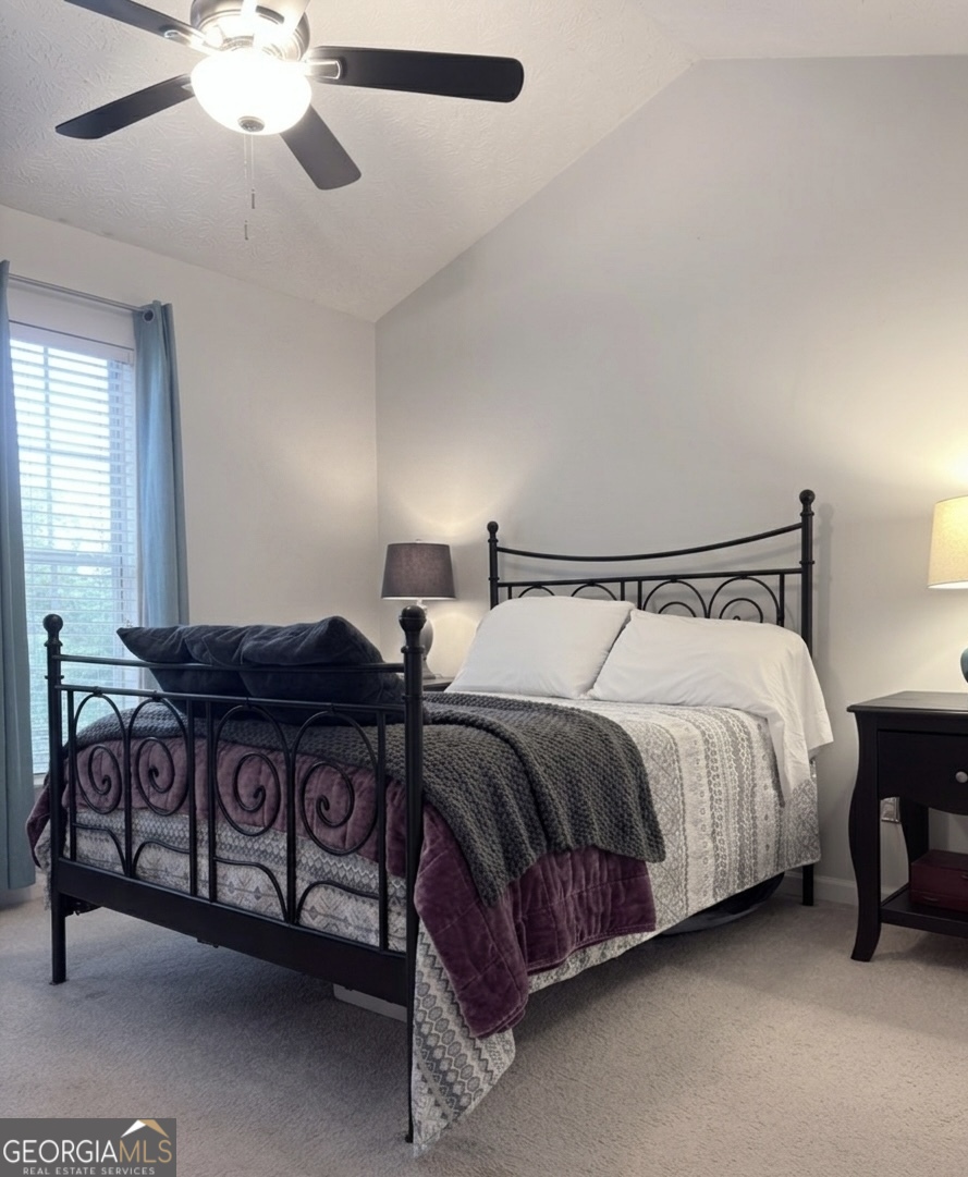 2851 Walden Lake Bend Decatur, GA 30035 - Photo 9 of 17 a spacious bedroom with a bed and a chandelier