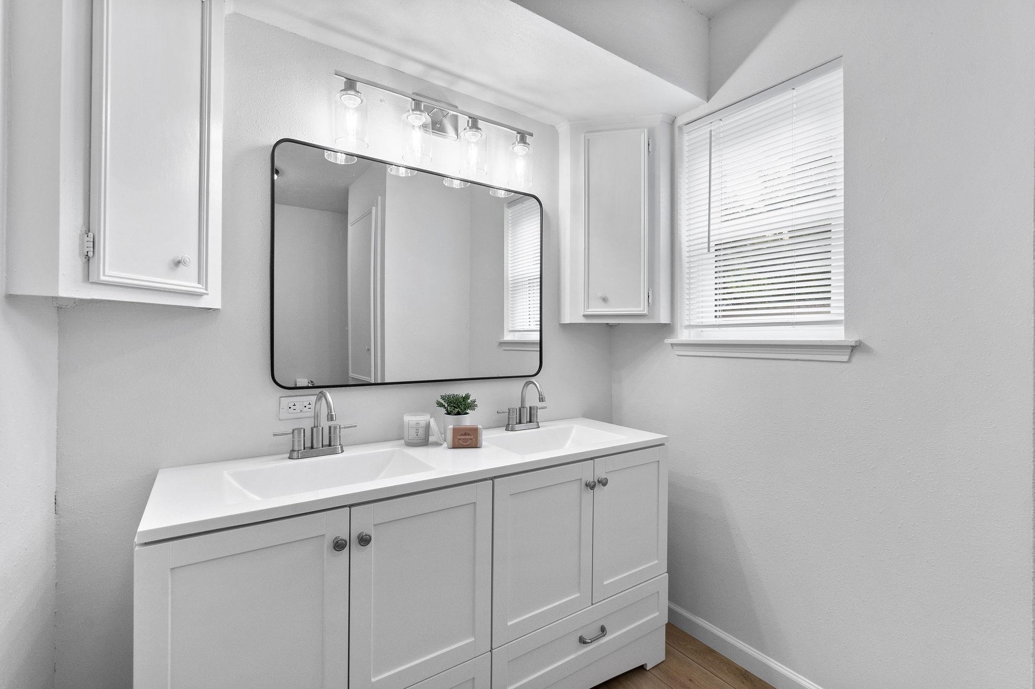 21710 Glenbranch Drive Spring, TX 77388 - Photo 19 of 32 a bathroom with a double vanity sink and mirror