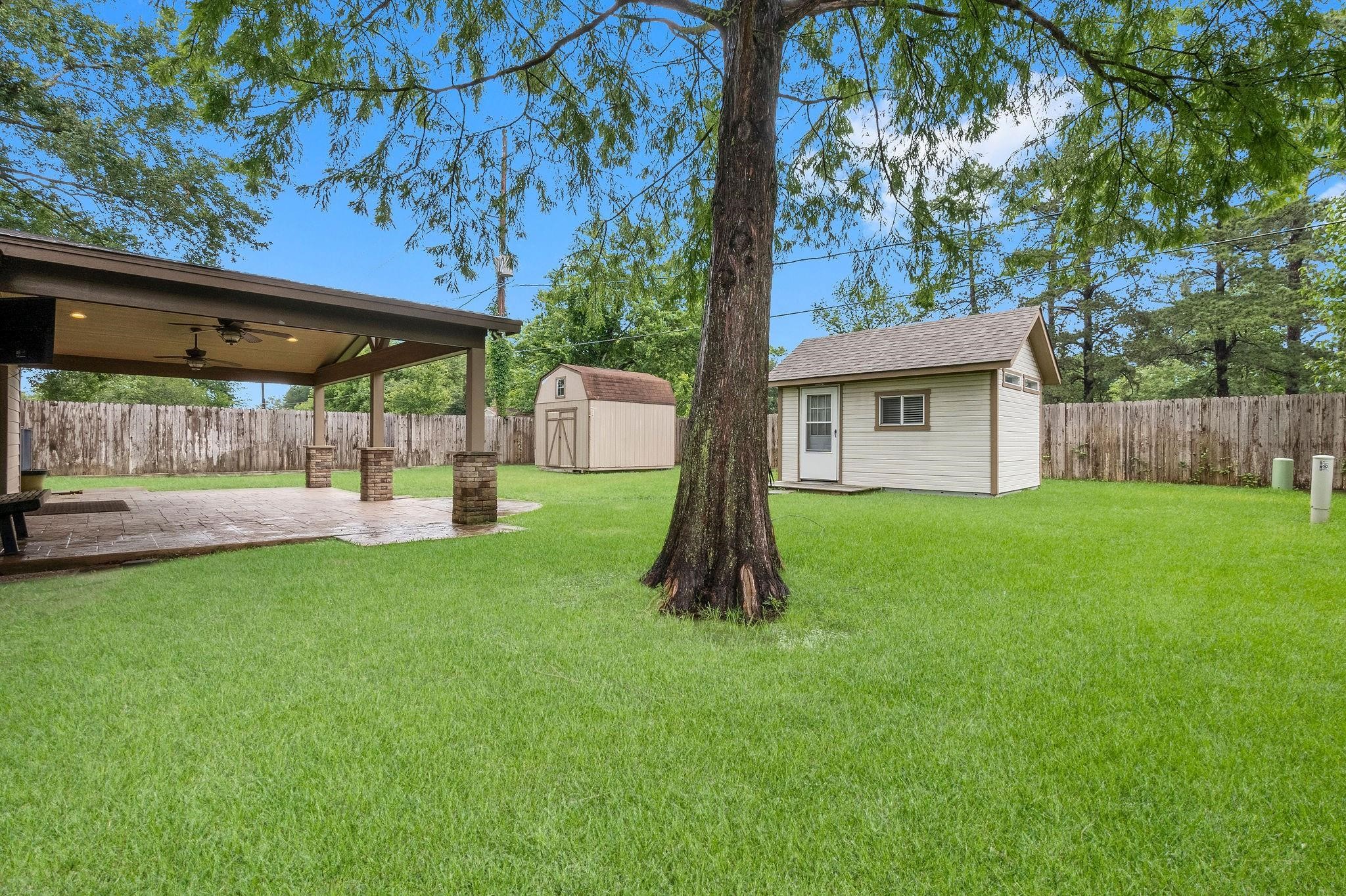 21710 Glenbranch Drive Spring, TX 77388 - Photo 26 of 32 a view of a backyard with a small cabin and chair
