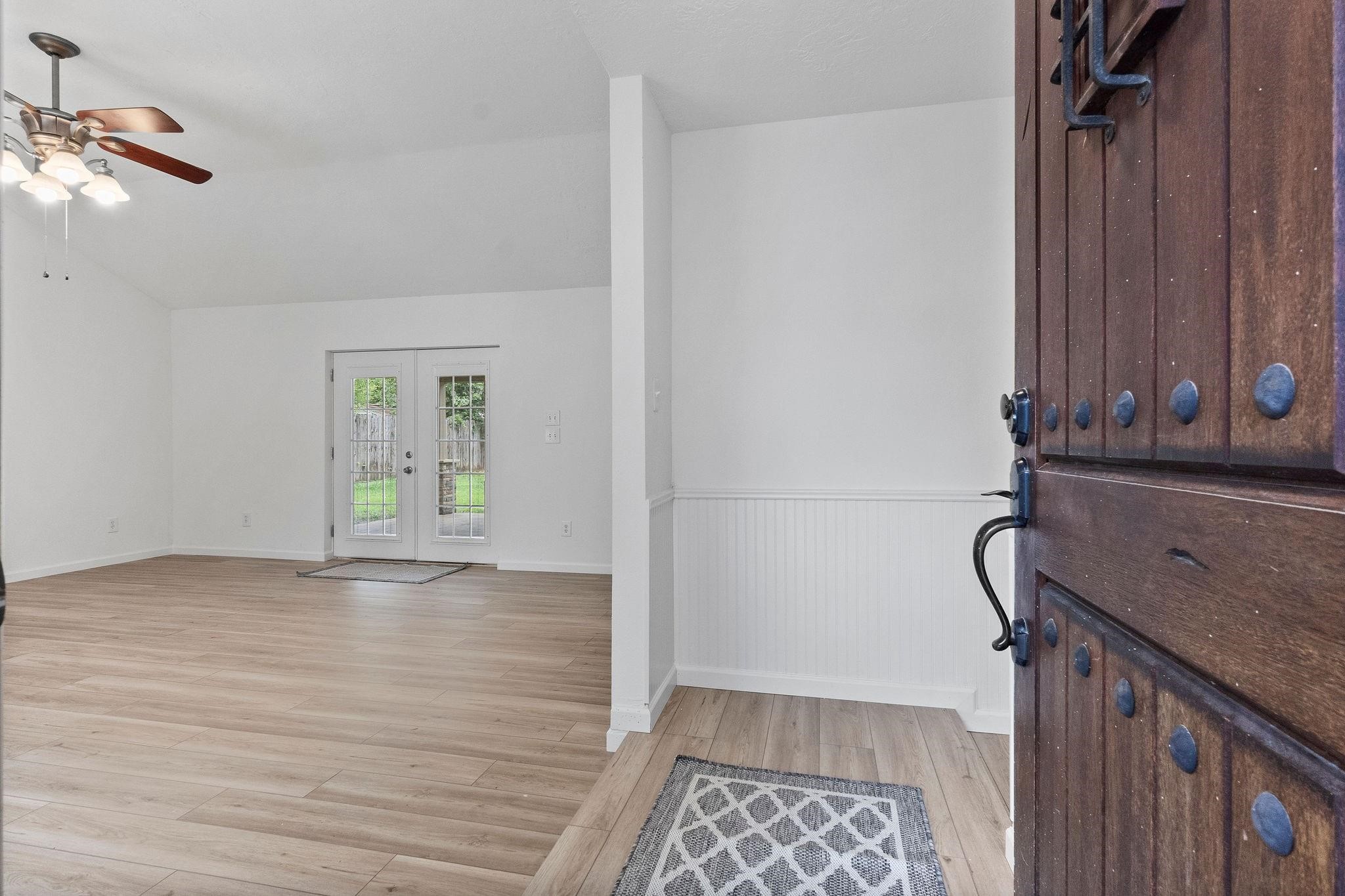 21710 Glenbranch Drive Spring, TX 77388 - Photo 5 of 32 a view of an empty room with wooden floor and a window