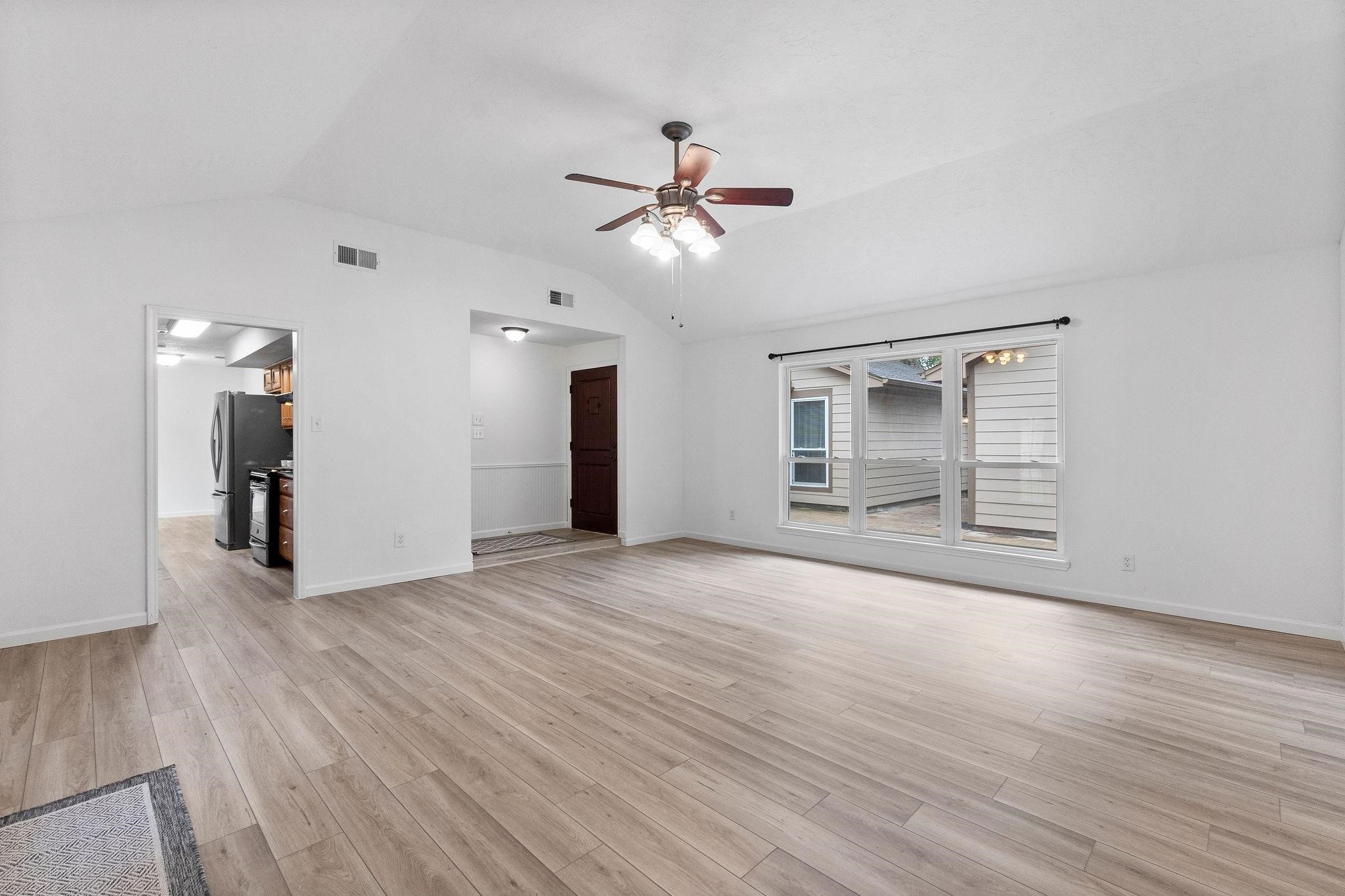 21710 Glenbranch Drive Spring, TX 77388 - Photo 8 of 32 a view of an empty room with wooden floor and a ceiling fan