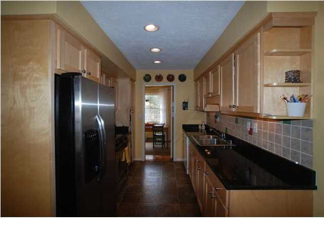 a black and white kitchen with stainless steel appliances