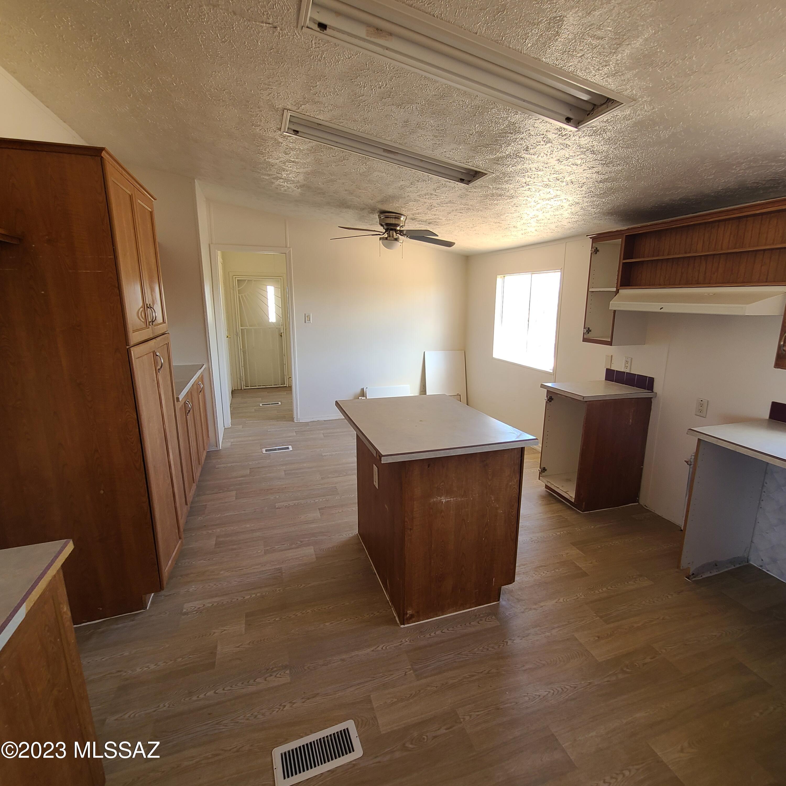8896 South Marstellar Road Tucson, AZ 85736 - Photo 12 of 39 a kitchen with stainless steel appliances a refrigerator and a stove