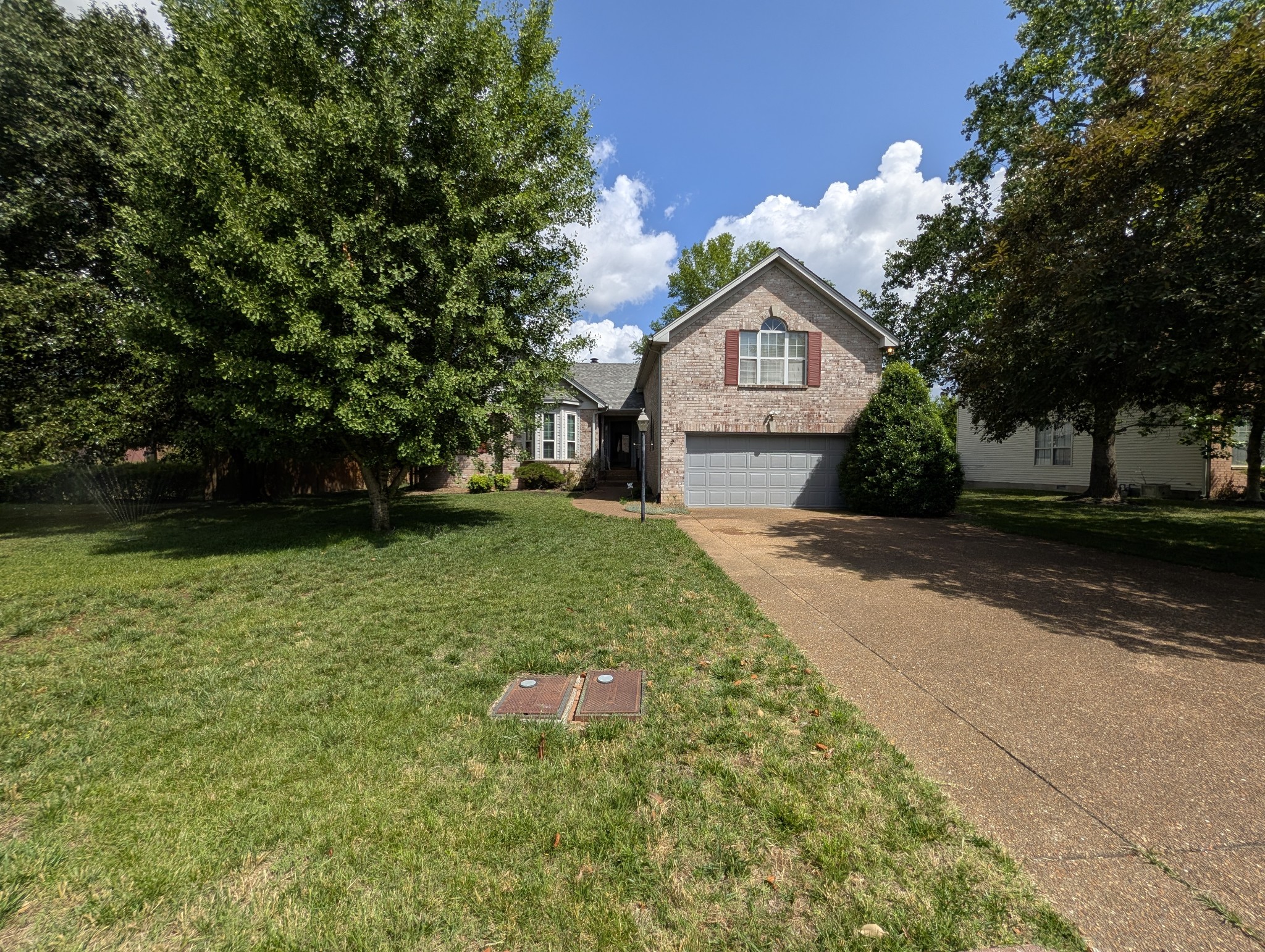 1401 Joe Pyron Drive Madison, TN 37115 - Photo 1 of 12 a front view of a house with a yard and garage
