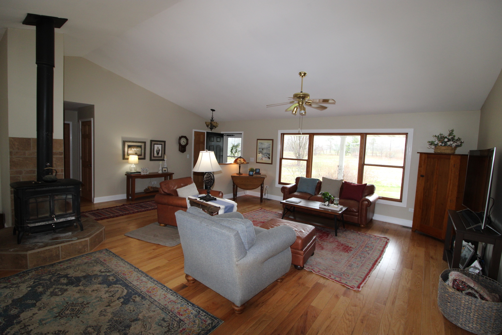 1709 Deerpass Road Marengo, IL 60152 - Photo 3 of 34 a living room with furniture flat screen tv and large window