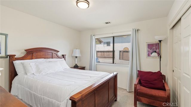 a dining room with furniture a chandelier and large window