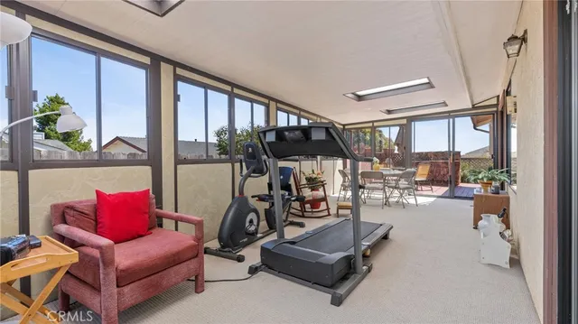 a living room with furniture a couch and a floor to ceiling window