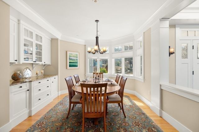 a dining room with furniture window and wooden floor