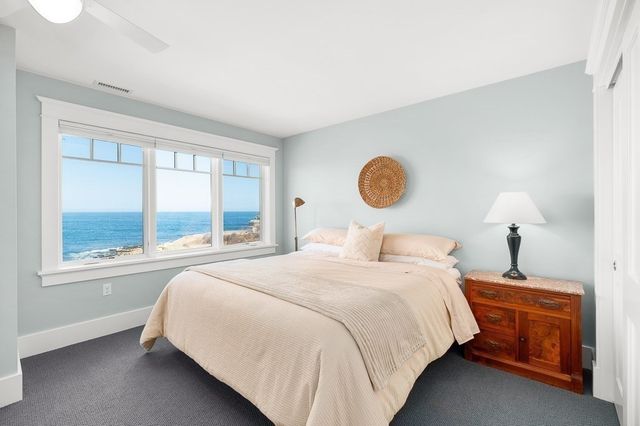 a bedroom with a bed lamp and window