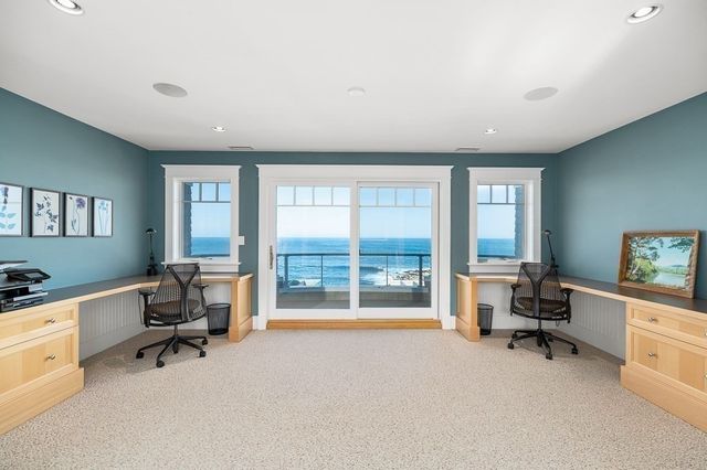 a view of a livingroom with workspace and a window