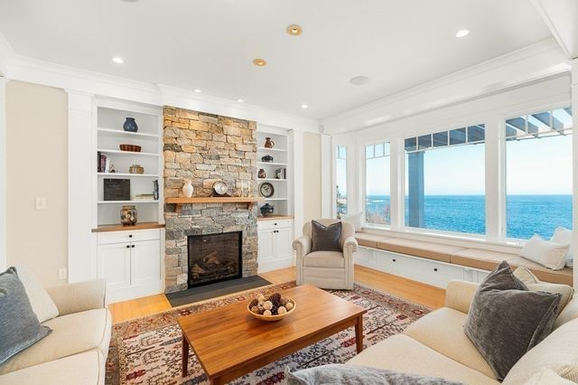 a living room with furniture large window and a fireplace